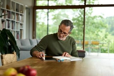 Man reviewing documents on a tablet - represents conscious protection through credit insurance